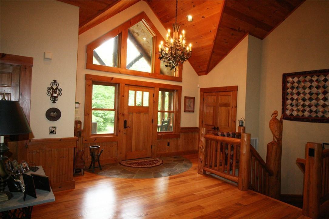 Entrance way with wooden, high vaulted ceiling, and a notable chandelier