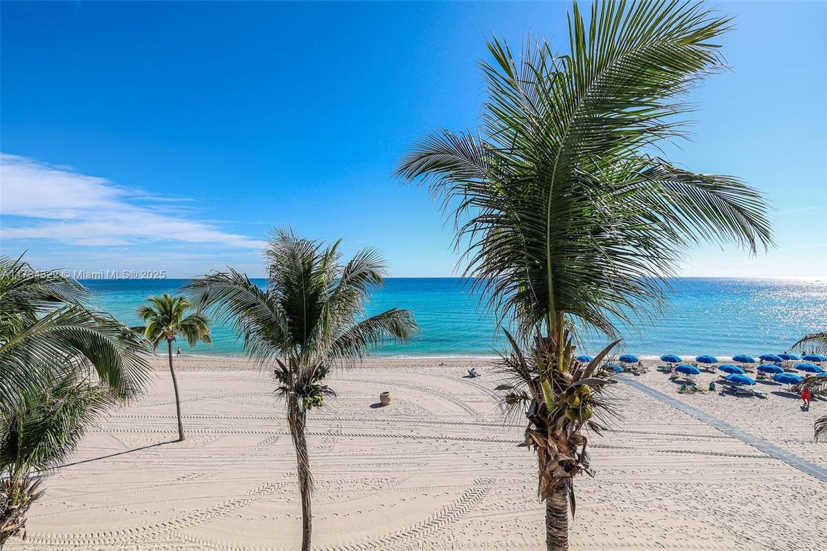 Direct beach access and panoramic ocean views throughout the unit.