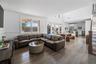 Living room with hardwood / wood-style floors, a towering ceiling, and french doors