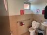Bathroom featuring tile patterned floors, toilet, and tile walls