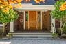 Doorway to property with a shingled roof