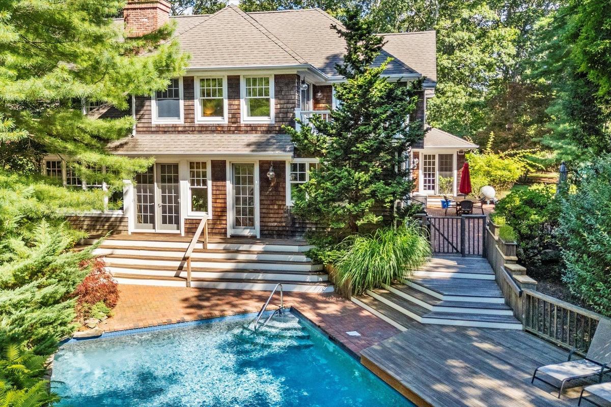 Back of house with french doors, an outdoor pool, a shingled roof, a chimney, and a patio area