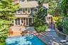 Back of house with french doors, an outdoor pool, a shingled roof, a chimney, and a patio area