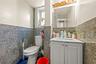 Bathroom featuring tile walls, vanity, and a wainscoted wall