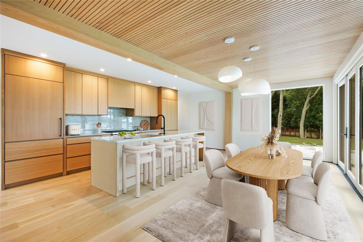 Virtual Kitchen & dining area with light wood-style floors and recessed lighting
