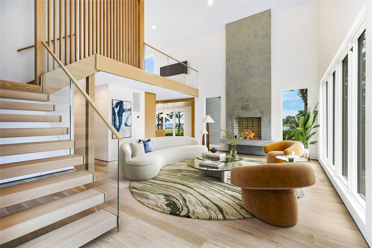 Virtual Staged Living room with a towering ceiling, stairway, a fireplace, and wood finished floors