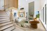 Virtual Staged Living room with a towering ceiling, stairway, a fireplace, and wood finished floors