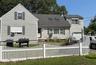 Traditional-style home featuring a shingled roof and an attached garage