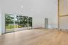 Spare room with recessed lighting, wood finished floors, a water view, and high vaulted ceiling
