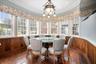 Dining area with wainscoting, wood walls, hardwood / wood-style floors, and ornamental molding