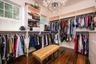 Walk in closet with a chandelier and hardwood / wood-style floors