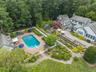 Drone / aerial view of a pool and a forest