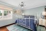 Bedroom with ornamental molding and wood finished floors