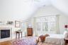 Bedroom featuring visible vents, multiple windows, lofted ceiling, and wood finished floors