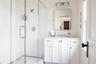Bathroom with a wainscoted wall, vanity, and a shower stall