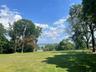 View of grassy yard with a water view