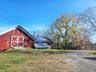 View of barn with a lawn