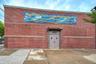 View of exterior entry featuring brick siding