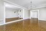 Unfurnished room with a chandelier, baseboards, and crown molding