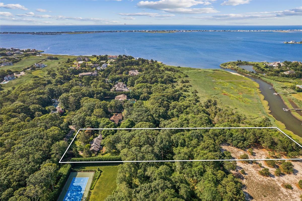 Aerial overview of property's location featuring a nearby body of water and property boundaries highlighted