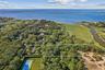 Aerial overview of property's location featuring a nearby body of water and property boundaries highlighted