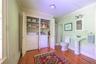 Washroom with baseboard heating, ornamental molding, dark wood-style flooring, and independent washer and dryer
