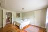 Bedroom with hardwood / wood-style flooring and baseboards