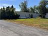 Manufactured / mobile home with entry steps and a front lawn