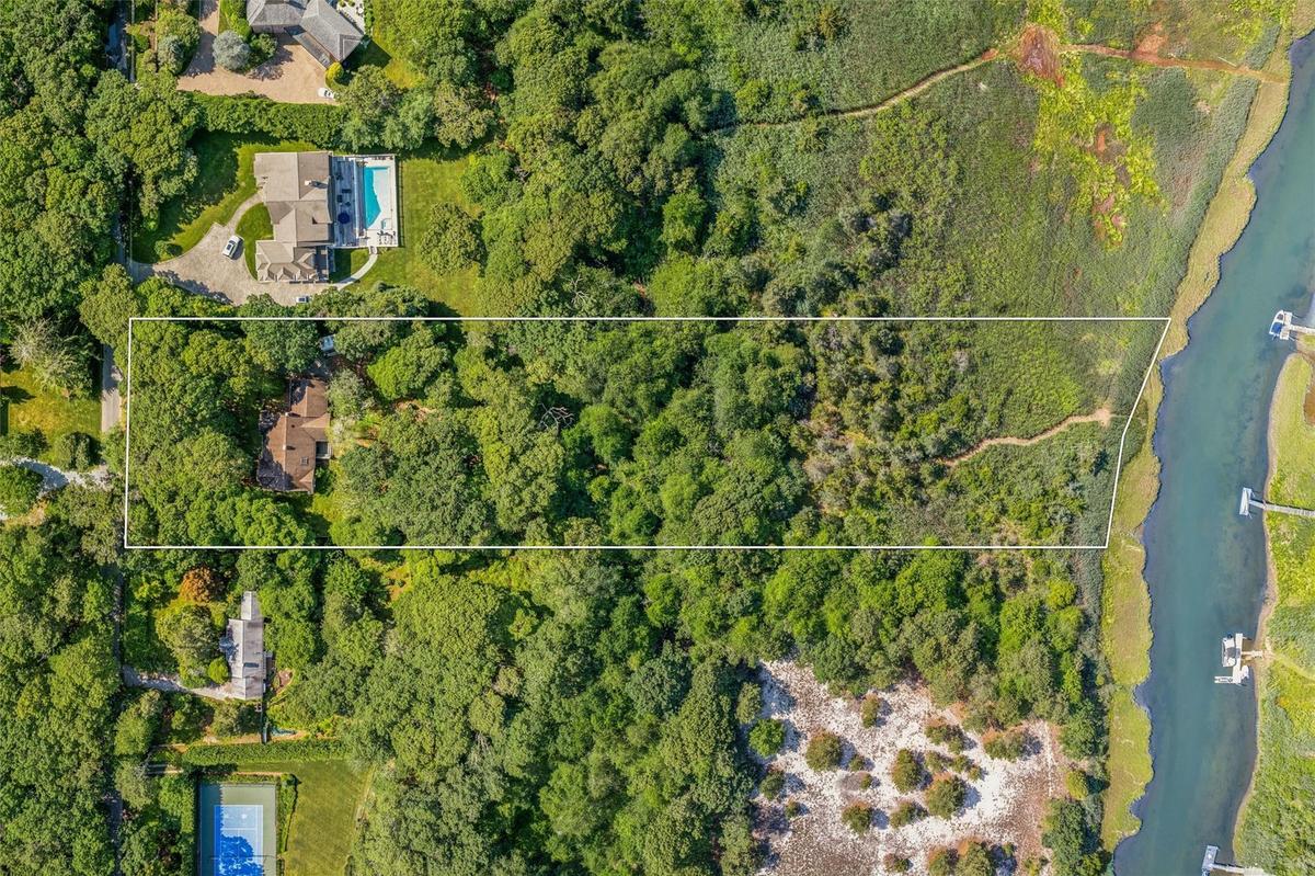 Aerial overview of property's location featuring a large body of water and property boundaries highlighted