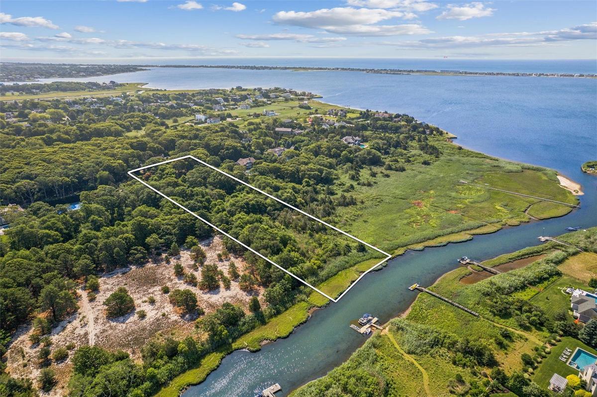 Aerial view of property's location featuring a large body of water and property boundaries highlighted
