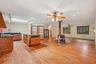 Kitchen with dark countertops, brown cabinets, baseboard heating, and a skylight