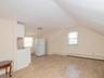 Bonus room featuring light wood finished floors, vaulted ceiling, and a baseboard heating unit