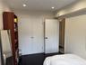 Bedroom featuring a closet, recessed lighting, and dark wood-type flooring