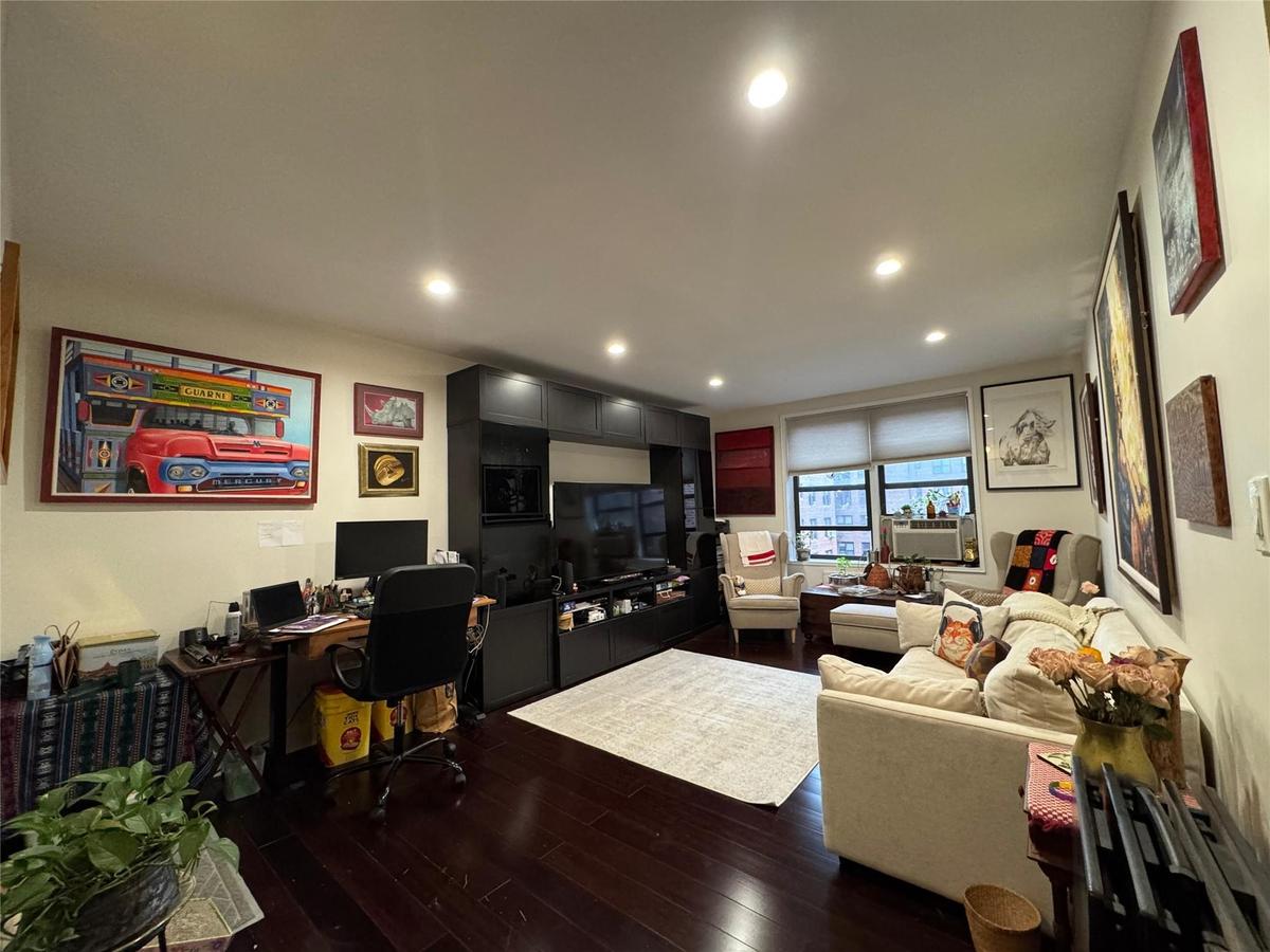 Living area featuring dark wood-type flooring, an office area, recessed lighting, and cooling unit