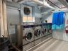 Community laundry room featuring washer and clothes dryer and tile patterned flooring