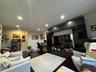 Living room with dark wood finished floors, recessed lighting, and a desk