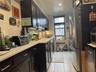 Kitchen with freestanding refrigerator, dark cabinetry, recessed lighting, and fridge