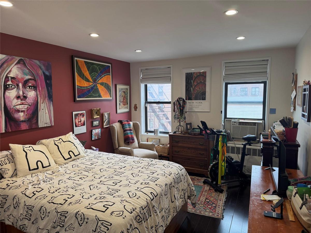Bedroom featuring hardwood / wood-style flooring, recessed lighting, and cooling unit