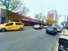 View of asphalt street featuring street lighting, curbs, and sidewalks