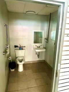 Bathroom with a paneled ceiling and tile patterned floors