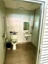 Bathroom with a paneled ceiling and tile patterned floors