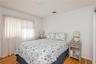 Bedroom featuring light wood-style flooring and baseboards