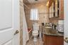 Full bath featuring tile walls, vanity, and backsplash