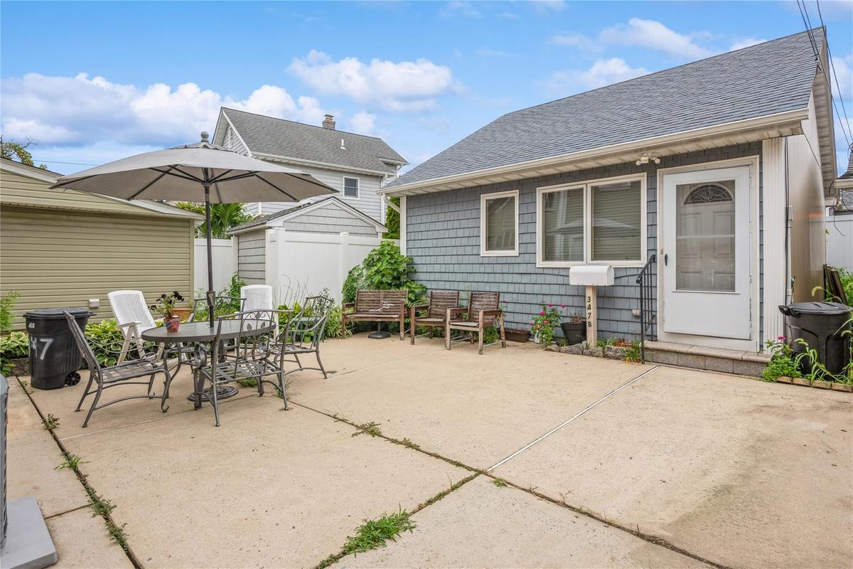 View of patio with outdoor dining space and a storage shed