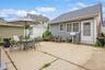View of patio with outdoor dining space and a storage shed