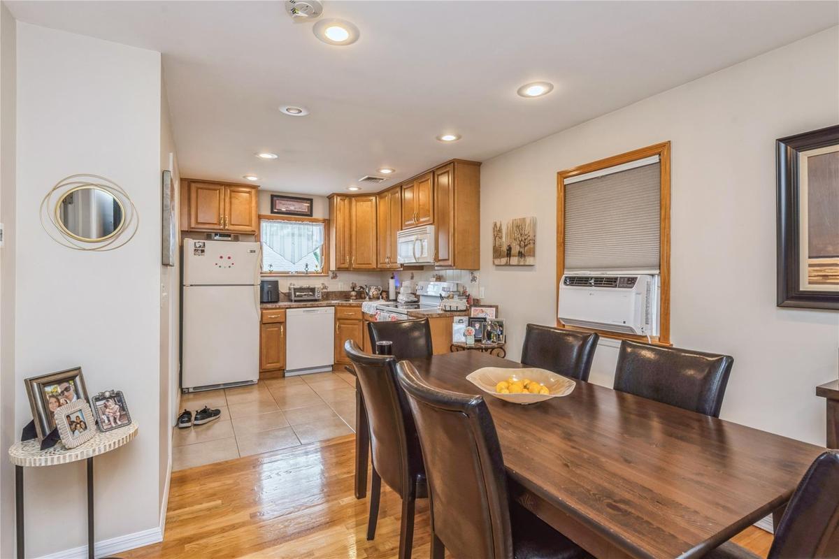 Dining space featuring light wood-style floors, recessed lighting, and cooling unit