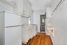 Kitchen with white appliances, dark wood-style floors, light countertops, white cabinetry, and open shelves