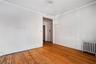 Unfurnished room with radiator heating unit, crown molding, and hardwood / wood-style floors