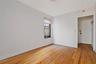 Unfurnished room featuring light wood finished floors and baseboards
