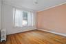 Empty room featuring radiator heating unit, crown molding, and hardwood / wood-style flooring